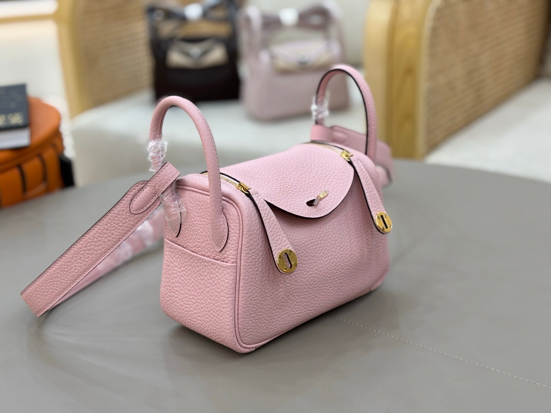 Rose Sakura Pink Soft Grain Mini Crossbody Bag With Round Gold Twist Lock and Wide Adjustable Strap