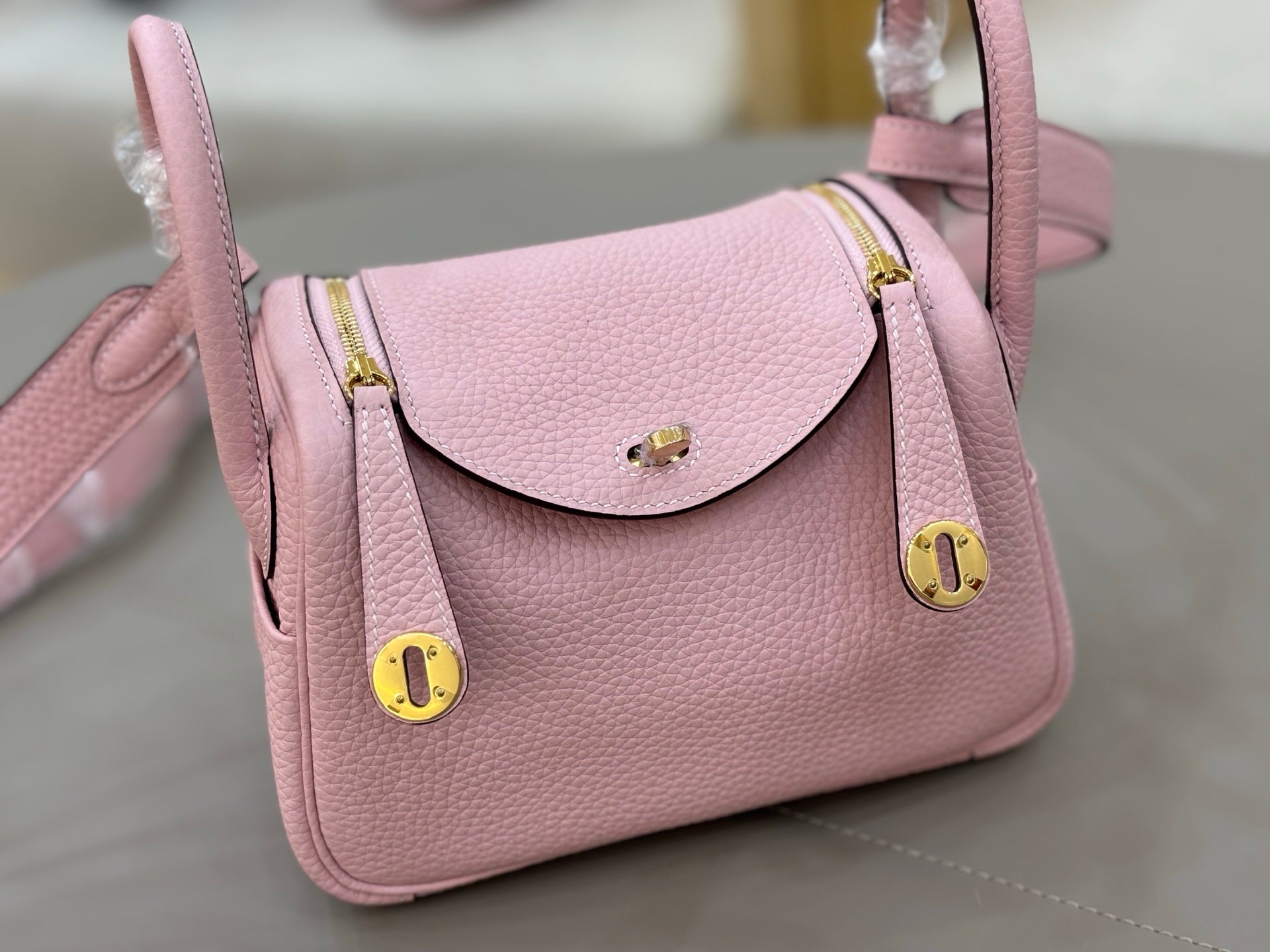 Rose Sakura Pink Soft Grain Mini Crossbody Bag With Round Gold Twist Lock and Wide Adjustable Strap