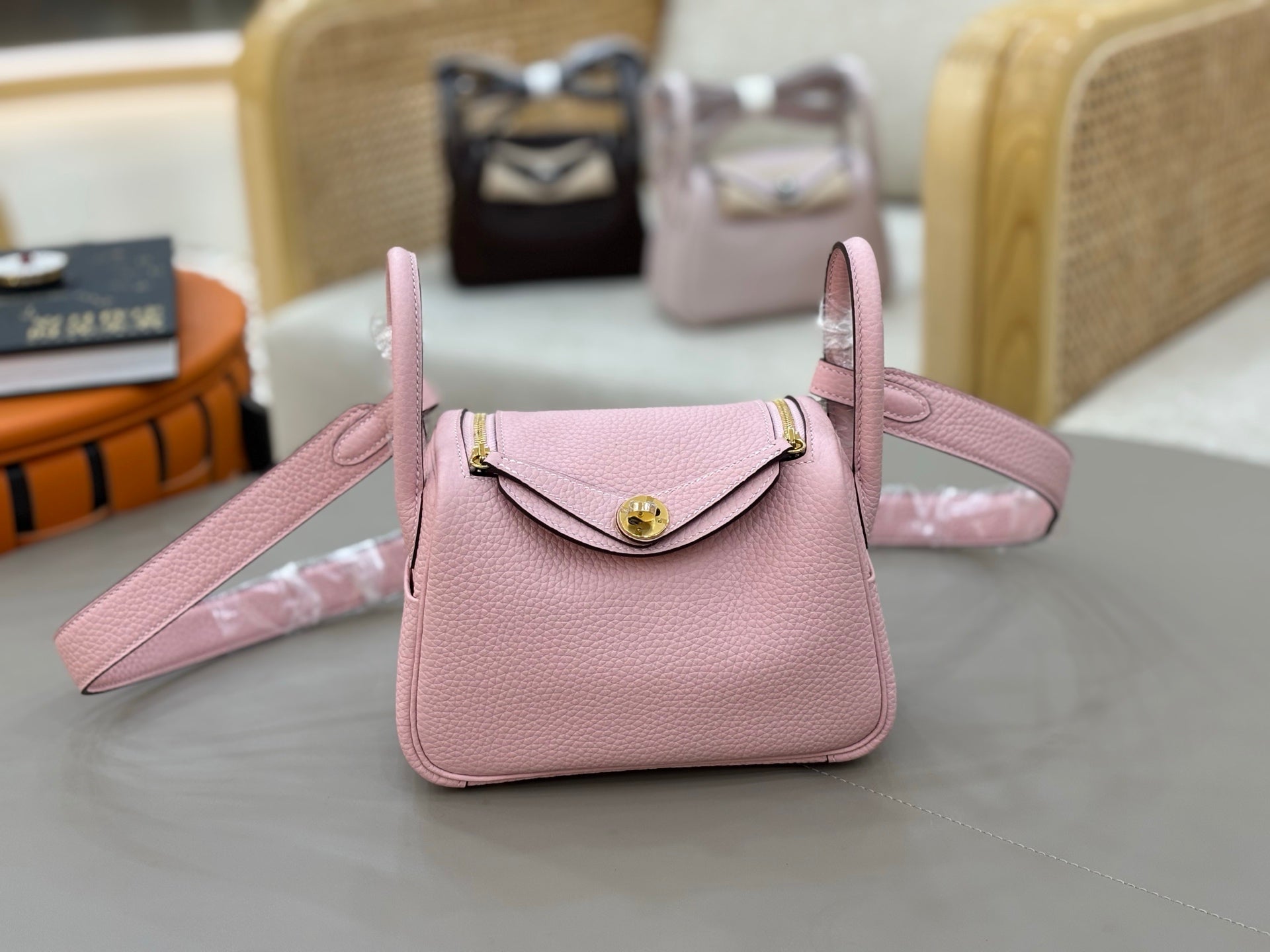 Rose Sakura Pink Soft Grain Mini Crossbody Bag With Round Gold Twist Lock and Wide Adjustable Strap