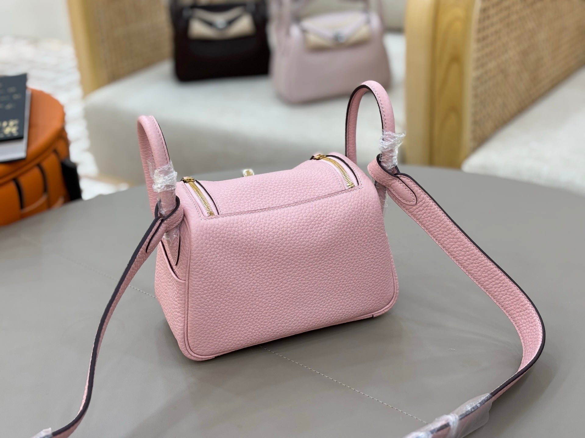 Rose Sakura Pink Soft Grain Mini Crossbody Bag With Round Gold Twist Lock and Wide Adjustable Strap